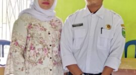 Darmawan, S.E didampingi Istri Nuraida, A.md, Keb, saat penyerahan berkas pendaftaran di Kantor Desa Pagar Puding Lamo